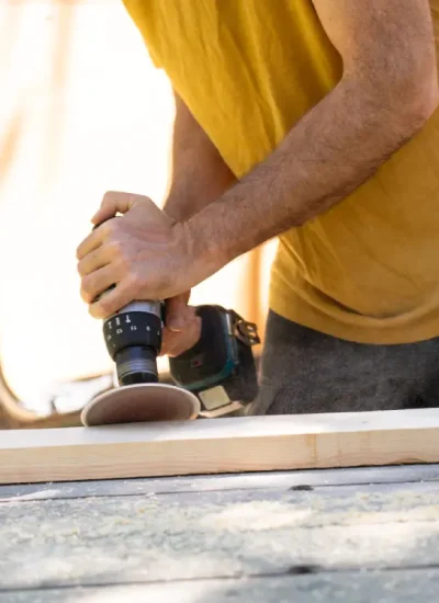carpenter-using-sander-power-tool-on-wooden-plank-2025-01-08-03-41-34-utc.webp