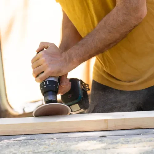 carpenter-using-sander-power-tool-on-wooden-plank-2025-01-08-03-41-34-utc.webp